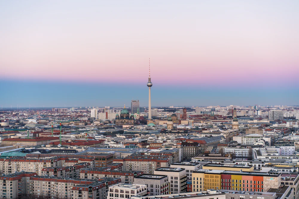 Berlin Panorama mit Fernsehturm Alex. Morgengrauen, pastellrosa und blau. Reise-Trends 2023